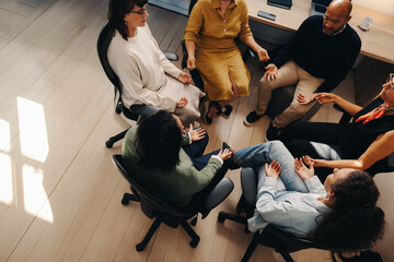 Colleagues practicing a breathing exercise together in a modern office setting