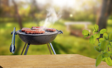 summer time in backyard garden with grill BBQ, wooden table, blurred background