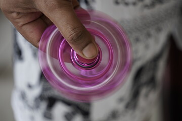 Hand Spinning a Pink Fidget Spinner in Motion
