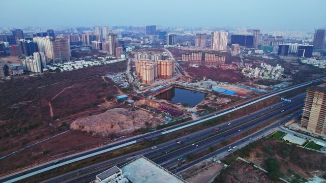Pacifica Hillcrest apartments with crowded buildings and empty land at financial district, nanakramguda, hyderabad, telangana, india. day time, semi orbit, drone shot, 4k.