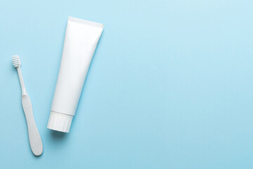 toothpaste and toothbrush top view with copy space on colored background. Flat lay. Dental hygiene. Oral care products on light background. Body care concept
