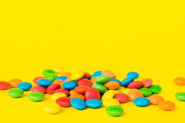 Pile of delicious colorful sweet candies on colored background top view. Confectionery decor