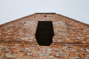 Weathered red brick wall of an abandoned house – old European architecture, history, and urban...