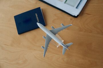 Top close up view of toy plane and passport