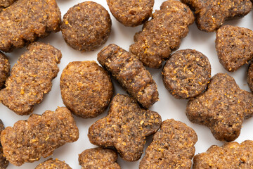 Dry pet food macro pieces, cat kibble closeup, dog pellets, small protein croquettes detailed