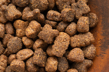 Dry pet food macro pieces, cat kibble closeup, dog pellets, small protein croquettes detailed