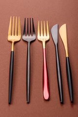 Knife and fork, cutlery on a brown dining table