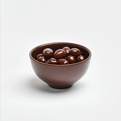A bowl of dates on a white background