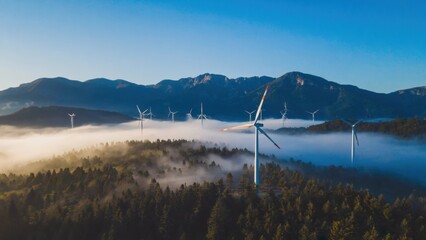 A mountainous landscape with wind turbines against a foggy backdrop, emphasizing the use of clean energy in nature.