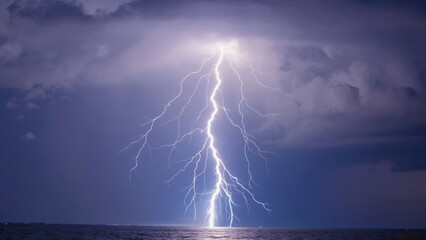 A dramatic storm over the ocean at night, with powerful lightning strikes illuminating the dark sky above.