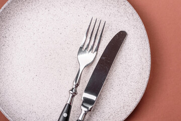 Empty ceramic plate on a monochrome brown background