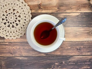 Cup of tea and crocheted doily mandala photo	

