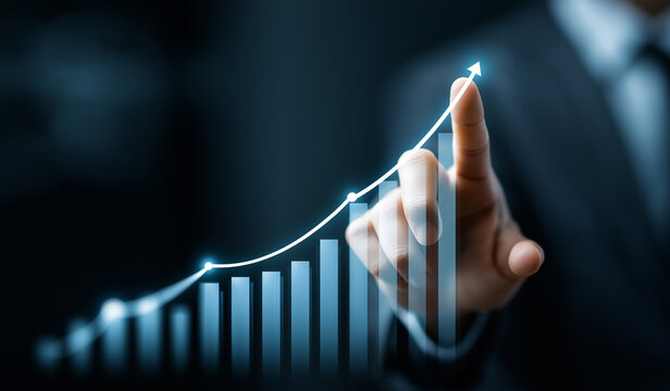 Businessman pointing at growth arrow on chart, symbolizing success and corporate development strategy.