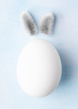 Naklejki Easter egg with the funny rabbit eggs  on blue watercolour background