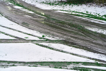 melting snow revealing muddy road