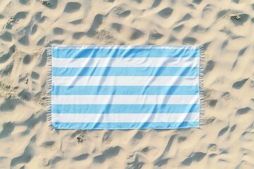 Striped beach towel on sand, aerial view
