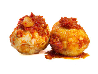 Balado chicken eggs with red chili sauce, typical Indonesian cuisine, isolated on white background