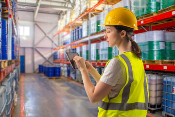 Warehouse worker woman. Storage of fuels and lubricants. Shelving with tanks for storage of...