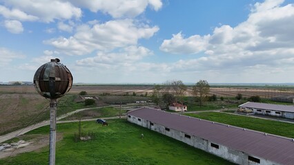 Drone picture of an old soviet water tank watching over an abandoned soviet farm in Romania, on the...