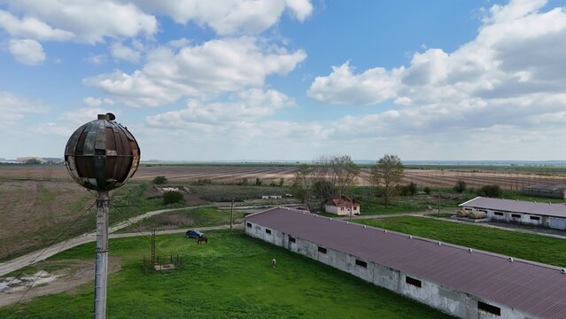 Drone picture of an old soviet water tank watching over an abandoned soviet farm in Romania, on the island of Borcea. Some parts of the farm have been rehabilitated to this day.