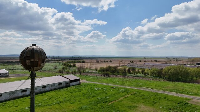 Drone picture of an old soviet water tank watching over an abandoned soviet farm in Romania, on the island of Borcea. Some parts of the farm have been rehabilitated to this day.