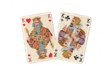 A pair of vintage playing cards of the same value isolated on a white background.