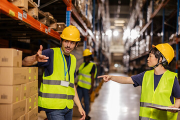 Warehouse workers discussing logistics and inventory management