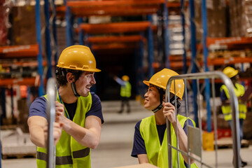 Warehouse workers moving inventory using hand pallet truck and talking