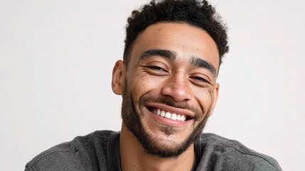 Obraz premium Handsome Young Man with Mixed Race Features Smiling Brightly