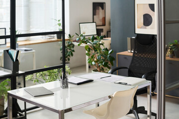 Modern office with table and green plants for meeting