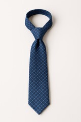  A formal navy blue necktie with a subtle geometric pattern featuring light blue squares.