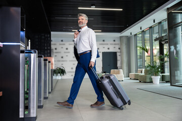 Passenger in suit heading to gate for his business trip