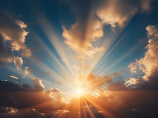 Sun rays break through dramatic clouds and stream powerfully warming the earth below