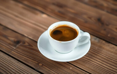 Obraz premium A Steaming Cup of Espresso on a Wooden Table