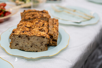 A close-up of a traditional Jewish Passover dish made with matzah and egg, served on an elegant blue and gold plate. A festive and cultural holiday food.