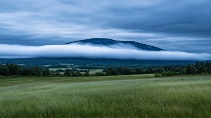 Rolling Clouds Over Majestic Mountain Landscape Under a Moody Sky in Lush Greenery