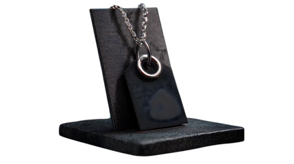 Black price tag with silver ring and chain, displayed on a black background in a product photography setup --ar 16:9 --v 7.0