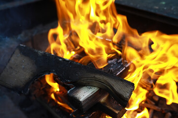 Close-up of Burning Firewood in Fireplace with Bright Flames and Intense Heat