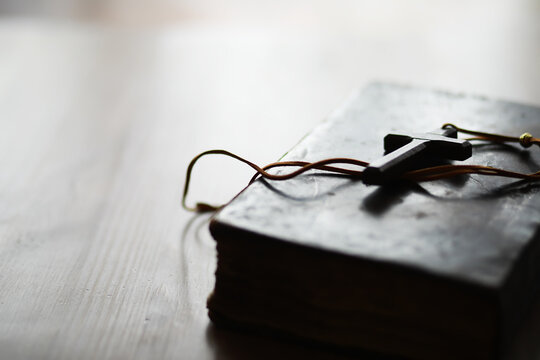 Old Bible and Wooden Cross on Light Wooden Table - Symbol of Faith, Religion, Christianity