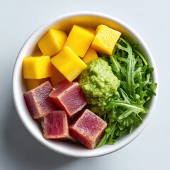 Beautifully arranged poke bowl with tuna, avocado, mango, and fresh greens