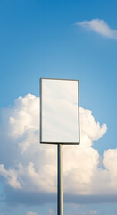 Blank signpost against blue sky with fluffy clouds