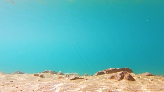 4K Under water shot of crystal clear water of the Chandra Taal Lake with sun rays visible through the clear water during a sunny day at Lahaul and Spiti district, Himachal Pradesh, India. Scenic Lake.