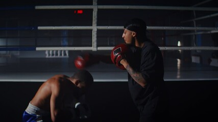 Skilled African American man does uppercuts dodging attacks - Powered by Adobe