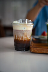 Glass of iced coffee in coffee shop, copy space and isolate concept.