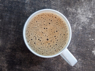 Creamy cappuccino in white cup from above