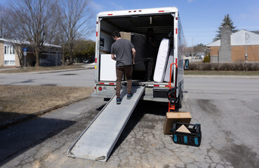 Man moving furniture out of a rental truck