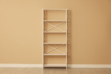 Empty shelving unit near beige wall indoors