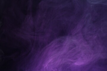 Beautiful smoke in neon lights on dark background