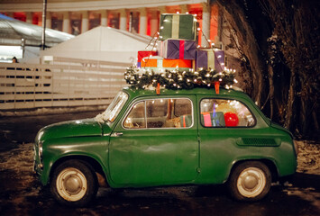 the car is decorated with presents and Christmas lights