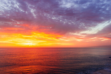 beautiful sunrise or sunset seascape with amazing calm sea water with waves and colorful amazing cloudy morning sky on background